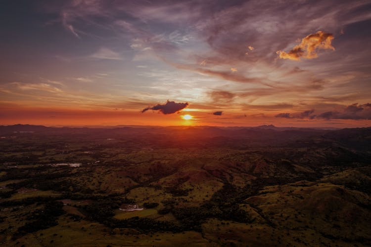 Scenic View Of Land During Sunset 