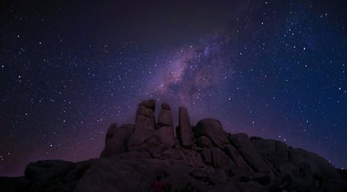 Free Starry Sky over a Rocky Mountain  Stock Photo