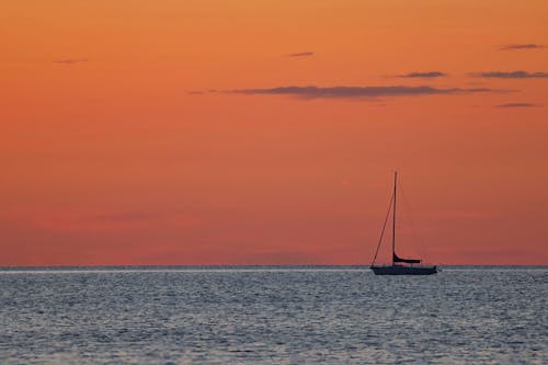 Free Silhouette of Sailboat on Body of Water Stock Photo