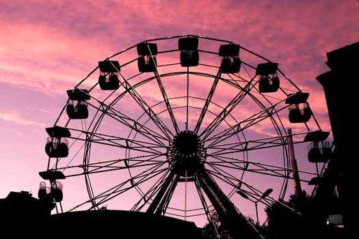White Ferris Wheel Under Orange Sky