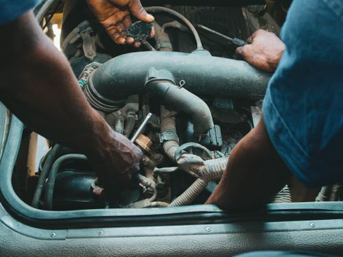 Mechanic working under the hood of a vehicle