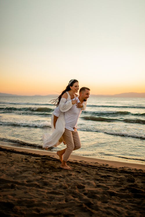 Happy Couple at the Beach during Sunset