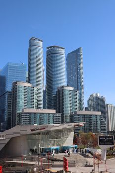 Panoramic view of Toronto's modern high-rise skyline on a sunny day.