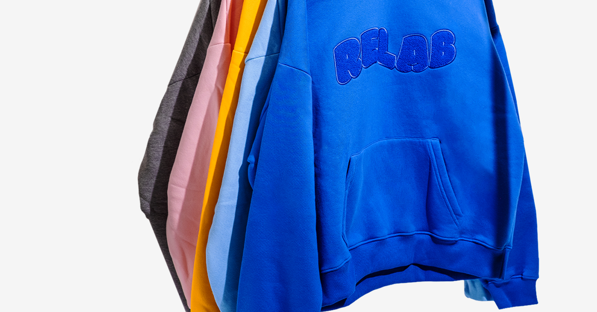 Hoodie Sweaters Hanging on Clothes Rack · Free Stock Photo