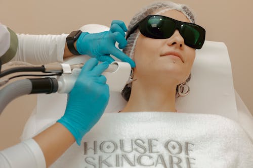 Woman in Protective Glasses Getting a Laser Beauty Treatment 