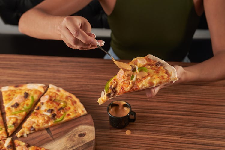 A Woman Eating A Pizza