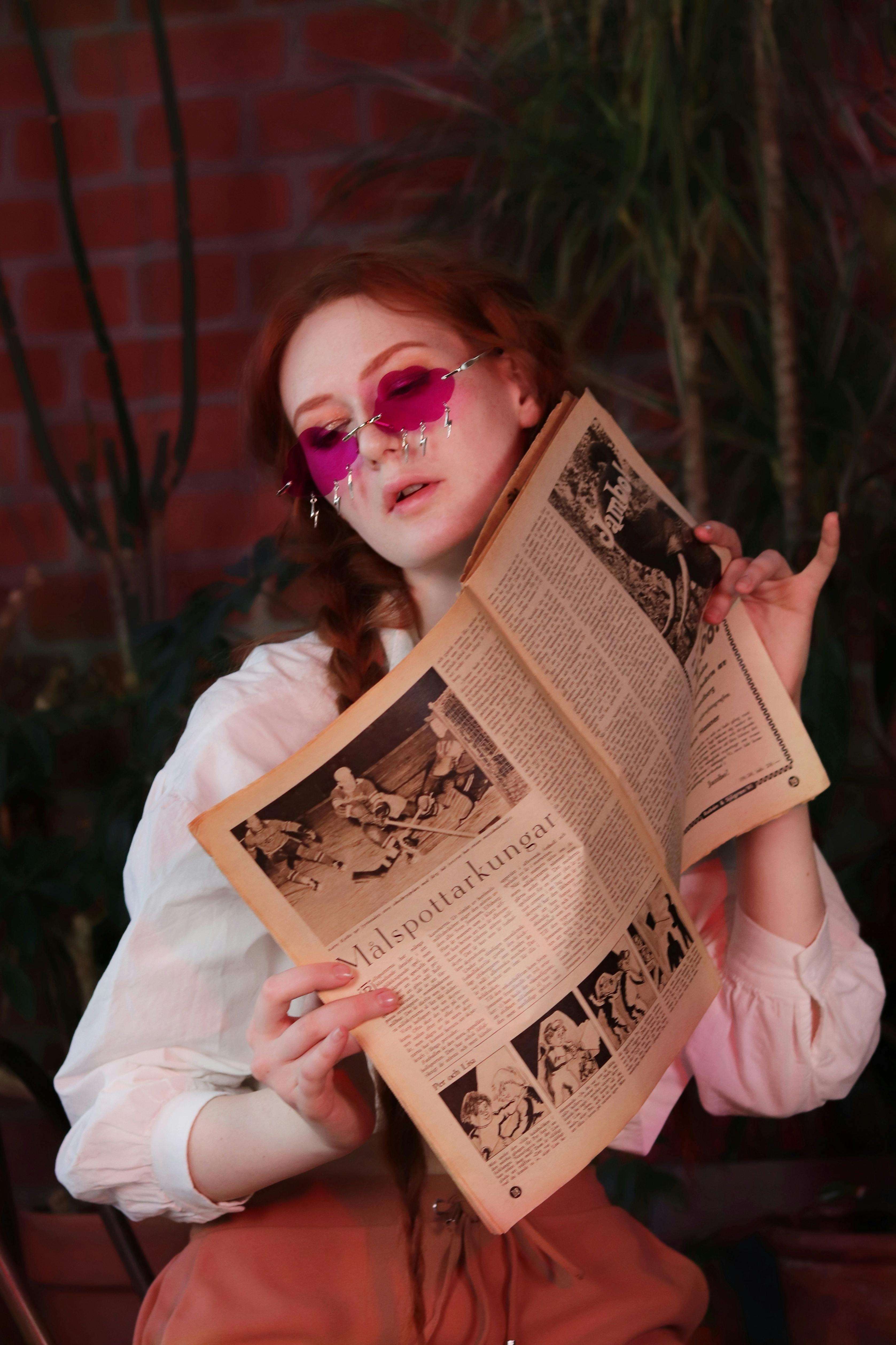 young stylish businessman in sunglasses reading business newspaper on  backseat of car Stock Photo by LightFieldStudios