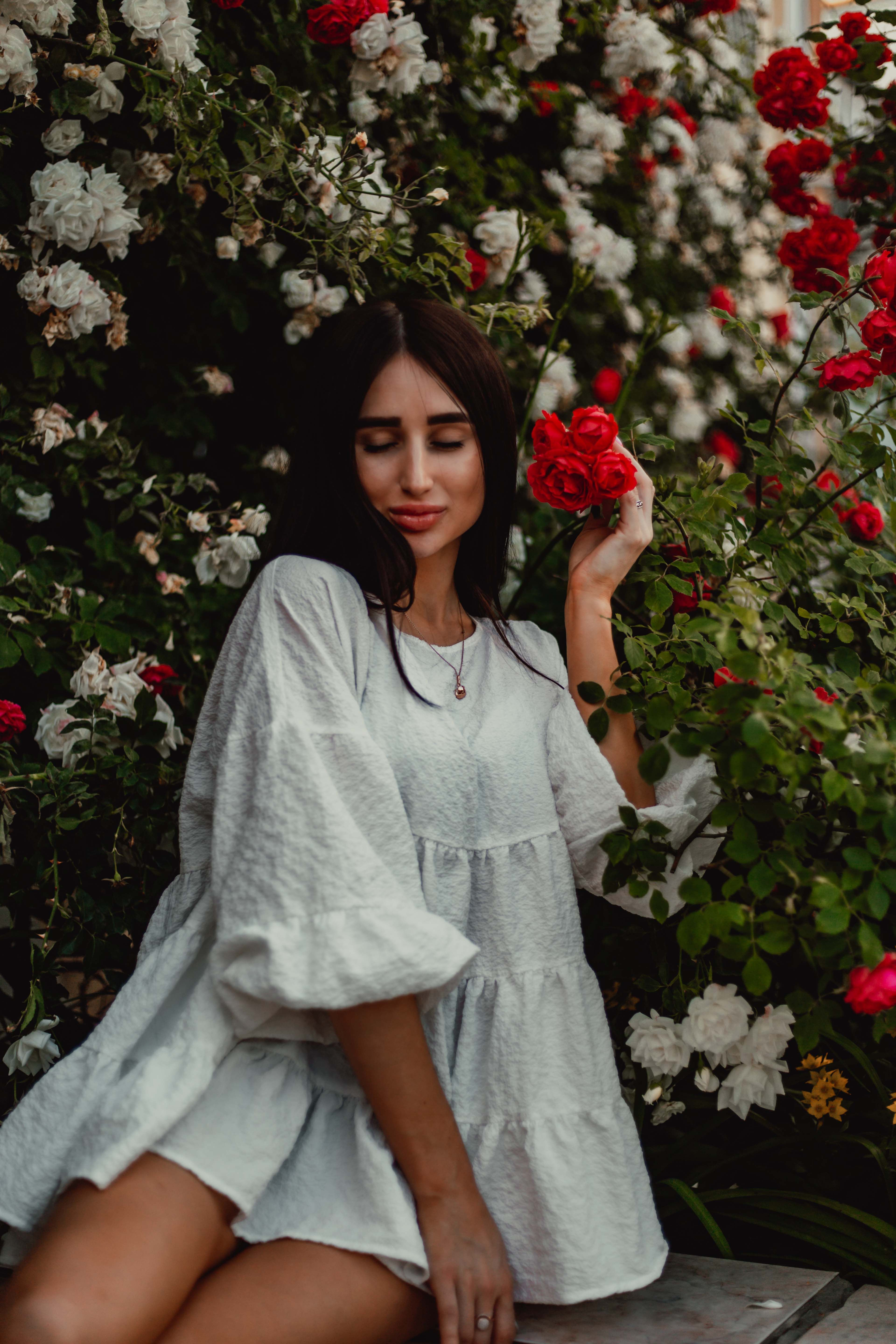 Woman in White Dress Holding Red Roses · Free Stock Photo
