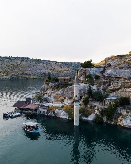Free Stunning aerial view of Halfeti's submerged minaret in Şanlıurfa, Turkey, surrounded by serene waters and rocky landscape. Stock Photo