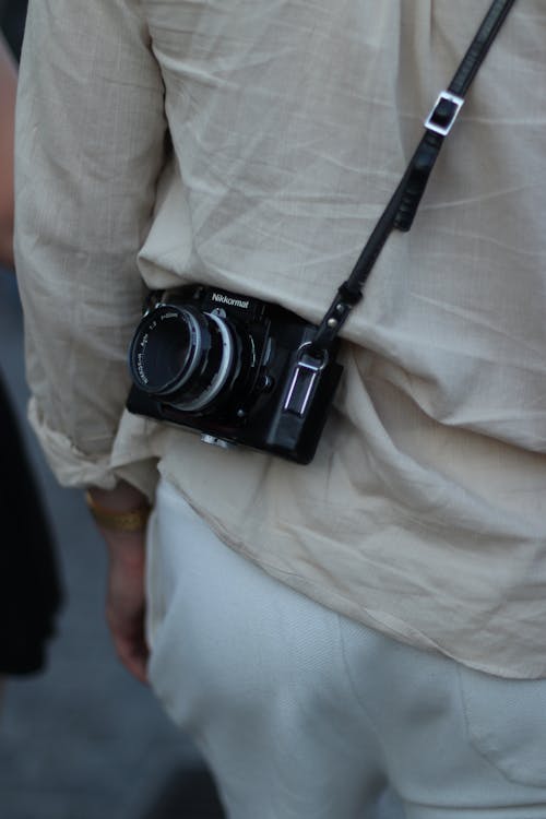 A Person Carrying a Black Camera 