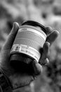 Grayscale Photo of Person Holding Camera Lens
