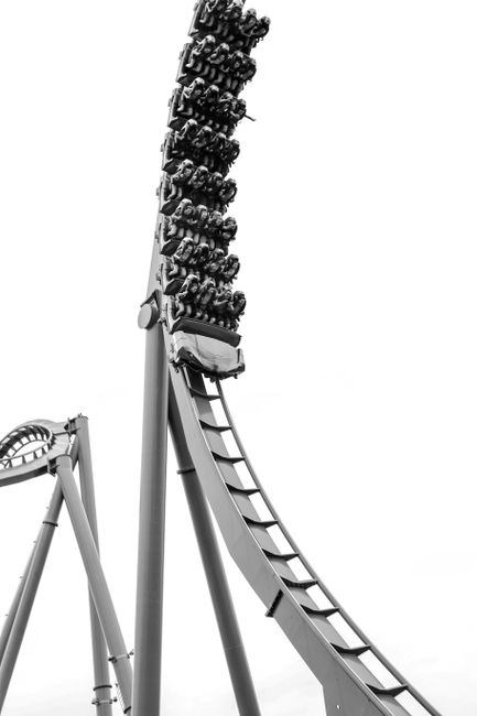 Thrilling roller coaster ride at a theme park in Orlando captured in black and white.
