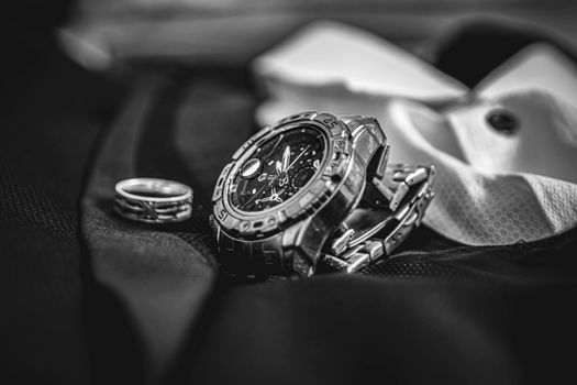 Grayscale Photo of a Wristwatch and Ring