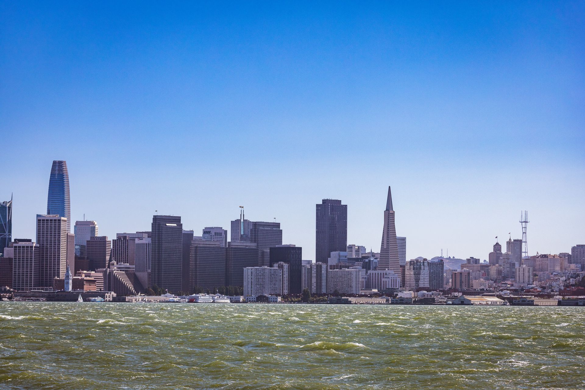 San Francisco Financial District skyline with iconic skyscrapers including the Transamerica Pyramid viewed from across the bay on a clear day