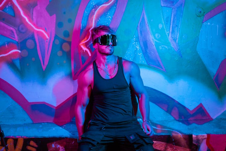 A Man Wearing Black Tank Top And Snow Goggles