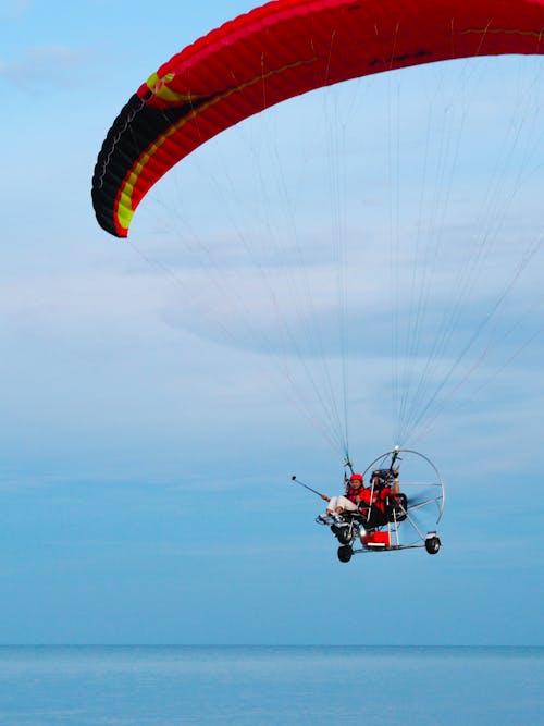 Free Person in Red and Black Parachute in Mid Air Stock Photo