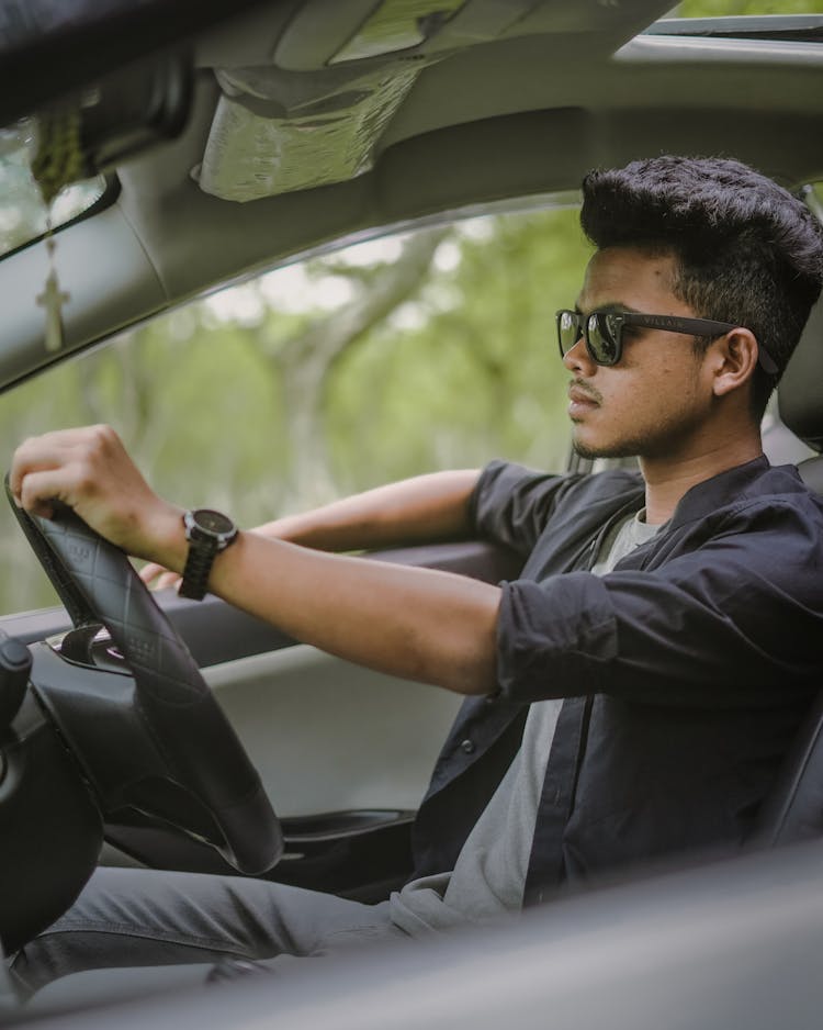 Man In Sunglasses Driving A Car