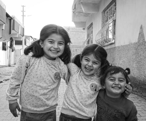 Three Young Girls Smiling Together 