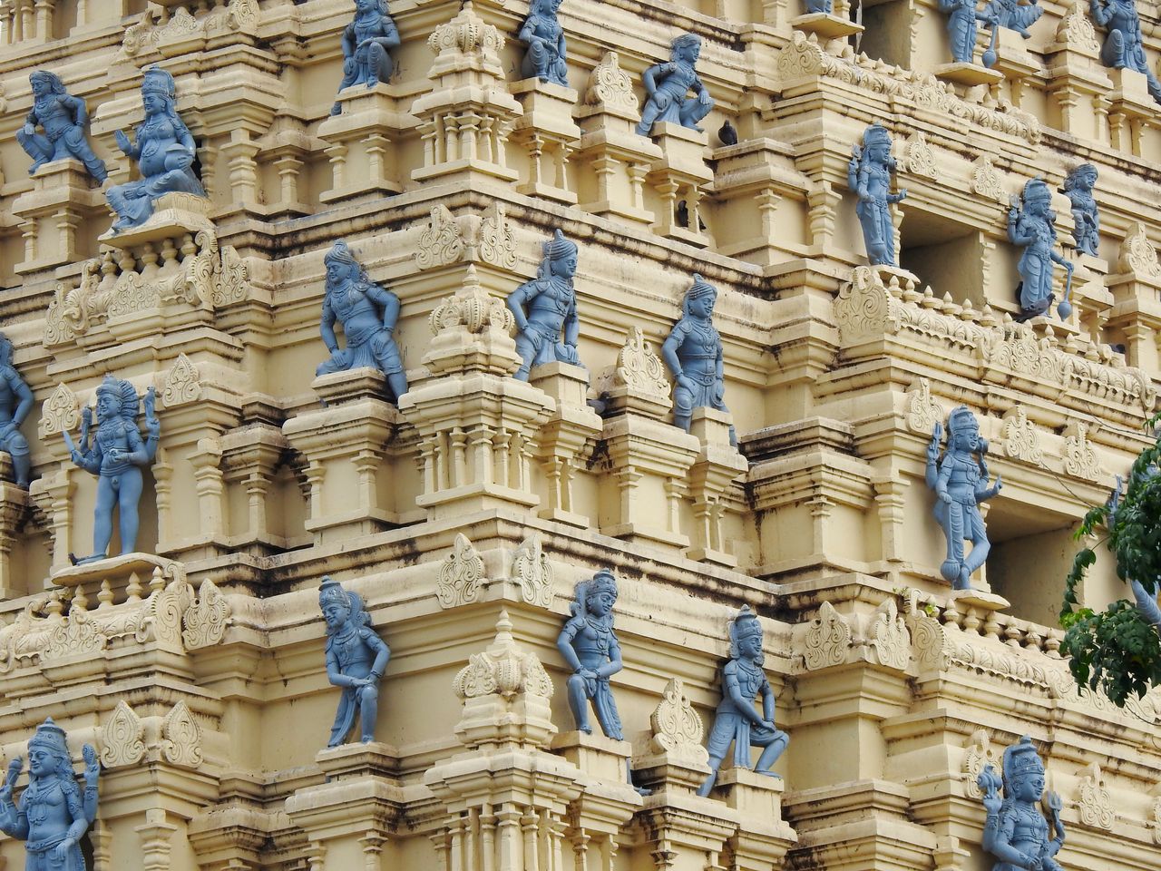 close up of a hindu temple s exterior adorned with detailed blue statu