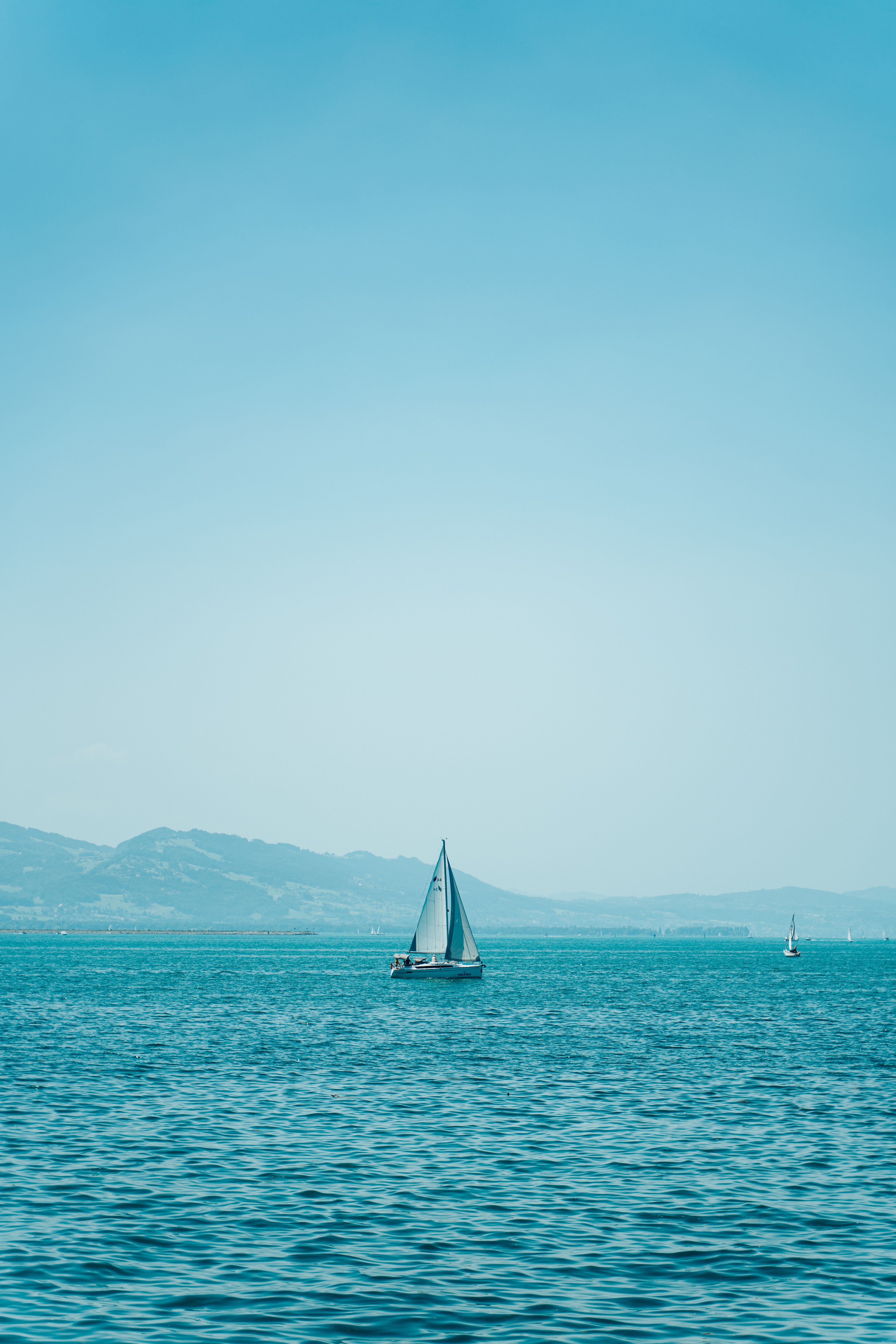 A Sailboat Sailing Under the Gloomy Sky · Free Stock Photo