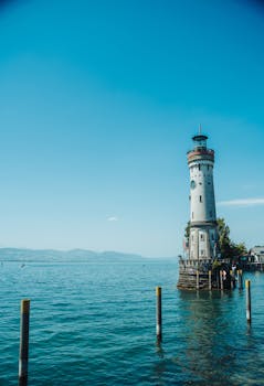 A stunning view of Lindau Lighthouse and Lake Constance, captured on a clear summer day.