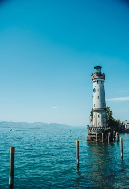 Free A stunning view of Lindau Lighthouse and Lake Constance, captured on a clear summer day. Stock Photo