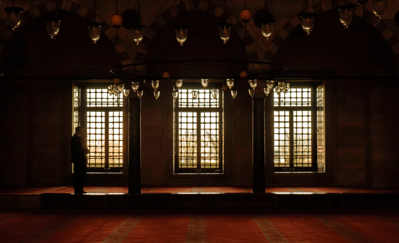 Peaceful mosque interior with patterned carpet