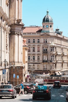 A beautiful street scene capturing historic architecture and lively atmosphere in Prague, Czechia.