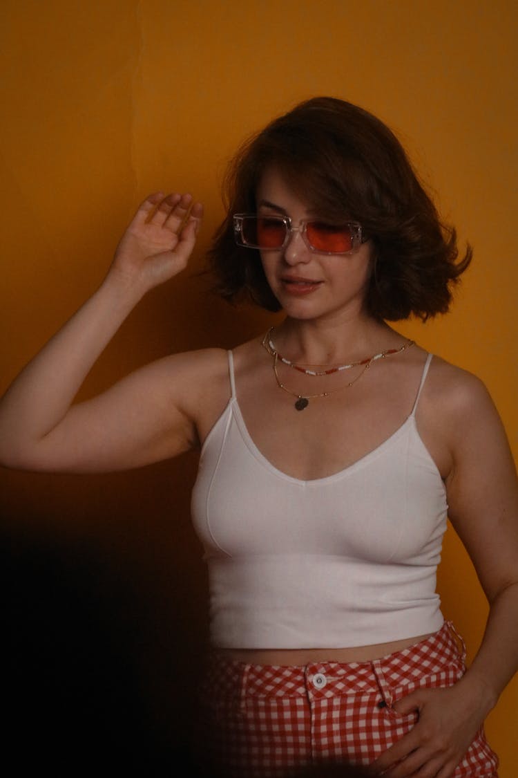 Woman In White Spaghetti Strap Wearing Sunglass While Posing At The Camera