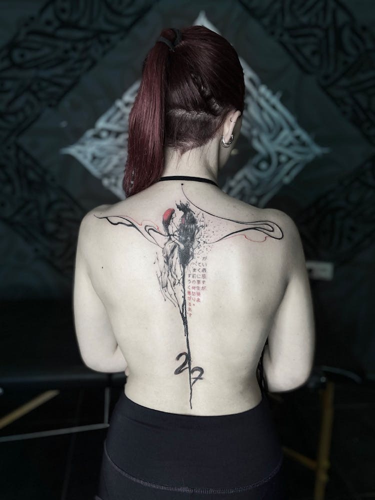 Back View Of A Woman With A Tattoo