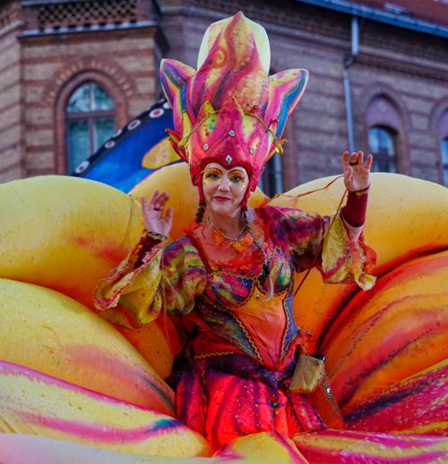 Free Colorful performer in elaborate costume at an outdoor festival parade. Stock Photo