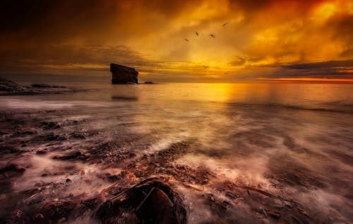 Ocean Waves Crashing on Shore during Sunset