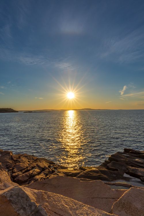 Free Breathtaking sunset over the Atlantic Ocean seen from Bar Harbor, Maine's rocky shores. Stock Photo