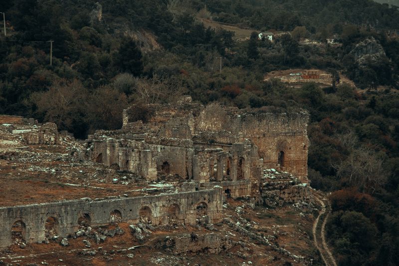 Aerial view of the historic Sahyun Castle ruins amidst lush greenery in Syria.