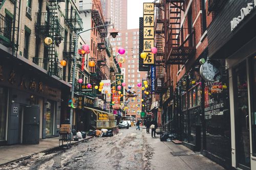 Free Vibrant street scene in New York's Chinatown with colorful lanterns and urban architecture. Stock Photo