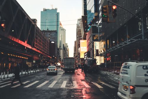 Free Iconic New York City street scene at twilight with traffic and skyscrapers. Stock Photo