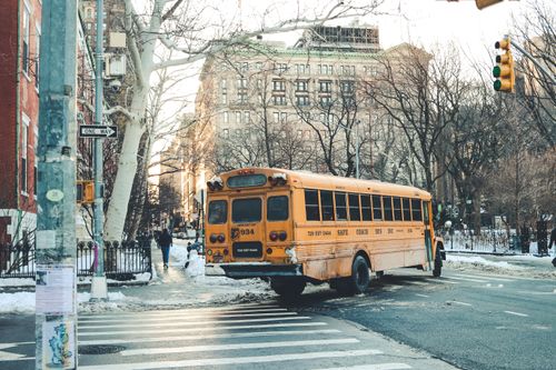 Free A classic yellow school bus navigating a snowy city street in winter, Washington, DC. Stock Photo