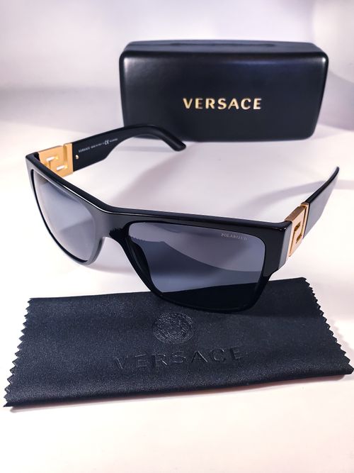 Free Elegant Versace sunglasses with gold accents, styled for luxury fashion lovers. Stock Photo