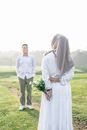 Muslim Couple Standing on a Field and Smiling 