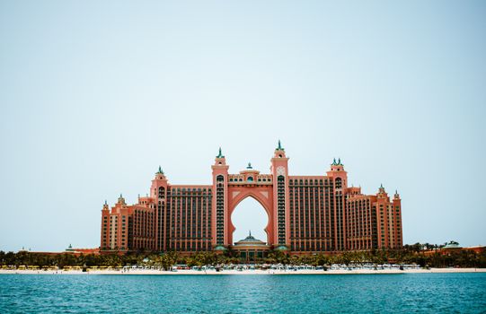 Spectacular view of Atlantis Hotel on Palm Jumeirah, Dubai, with a clear blue sky and tranquil ocean.