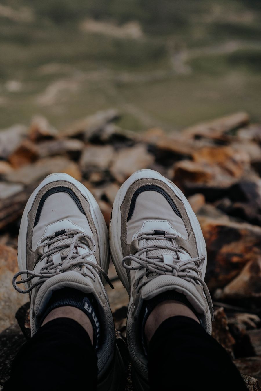 Grey sneakers on a rocky trail