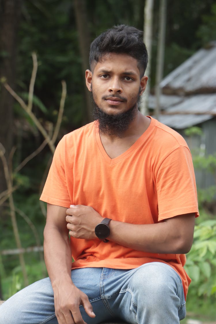 Man In Orange T Shirt And A Beard