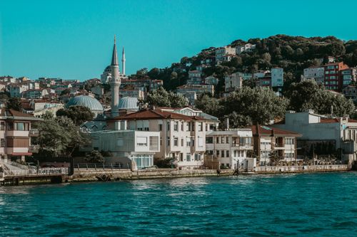 Free Idyllic Istanbul waterfront scene featuring Ortaköy Mosque and surrounding architecture. Stock Photo