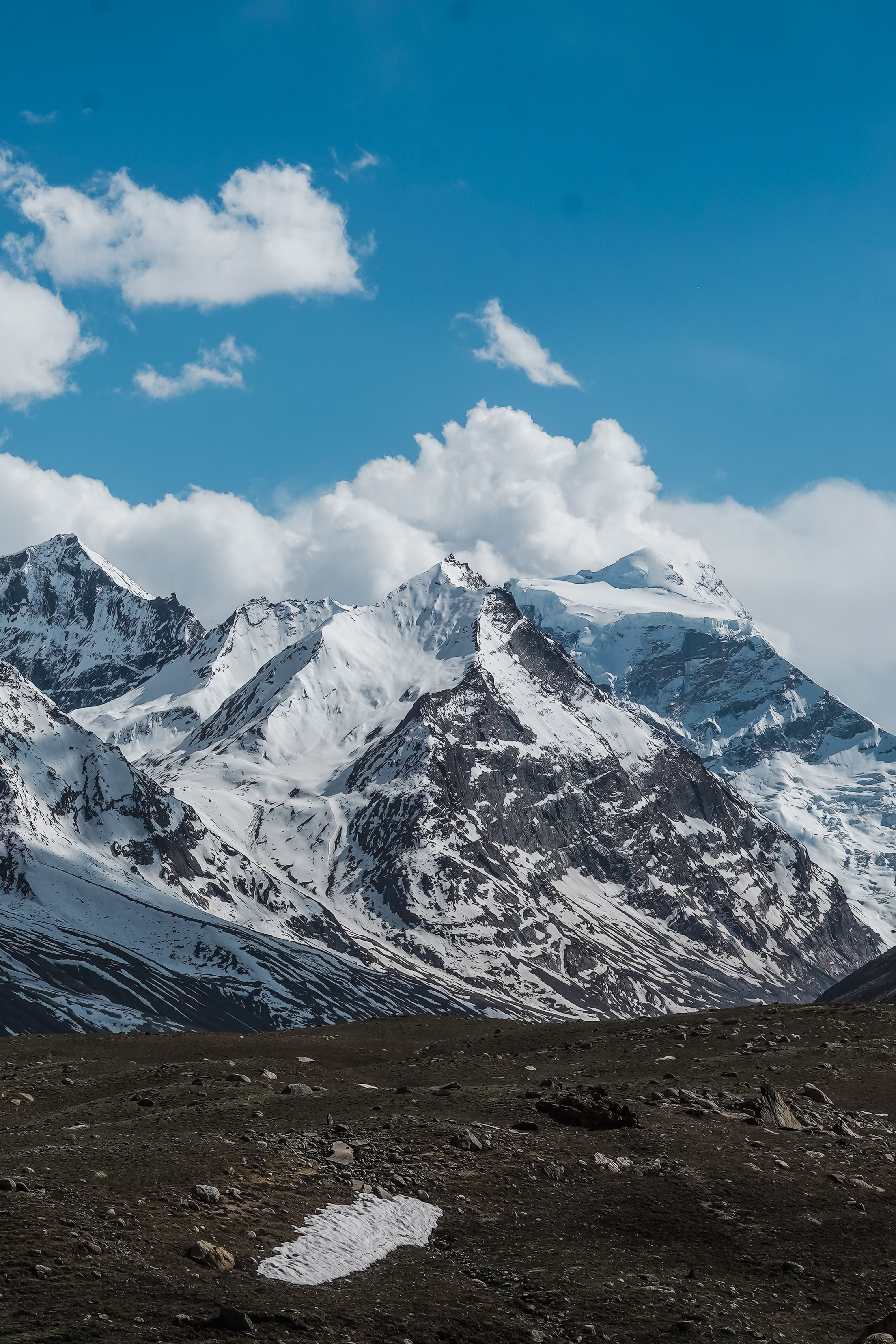 A Snow Covered Mountain Under the White Clouds and Blue Sky · Free ...