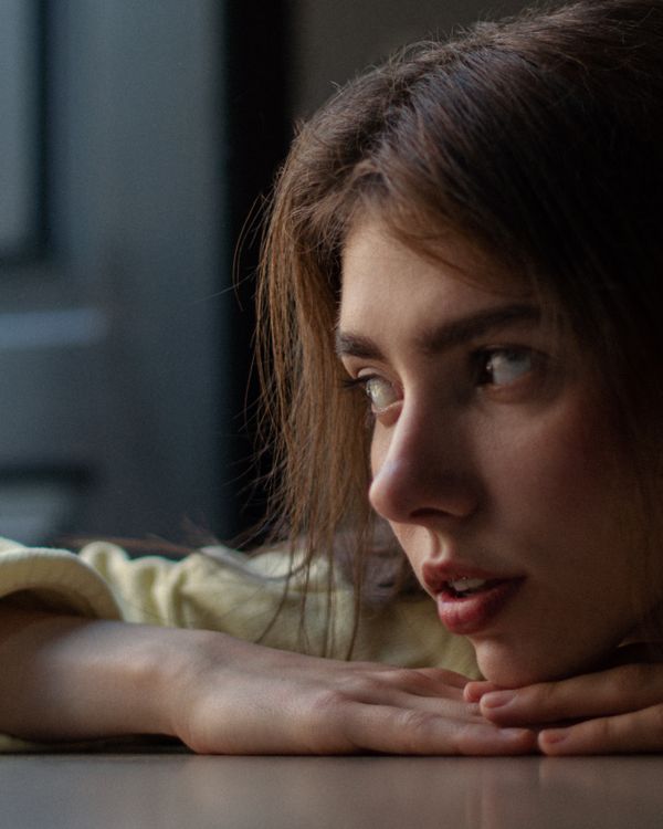 Young Woman Resting Her Chin on the Table · Free Stock Photo