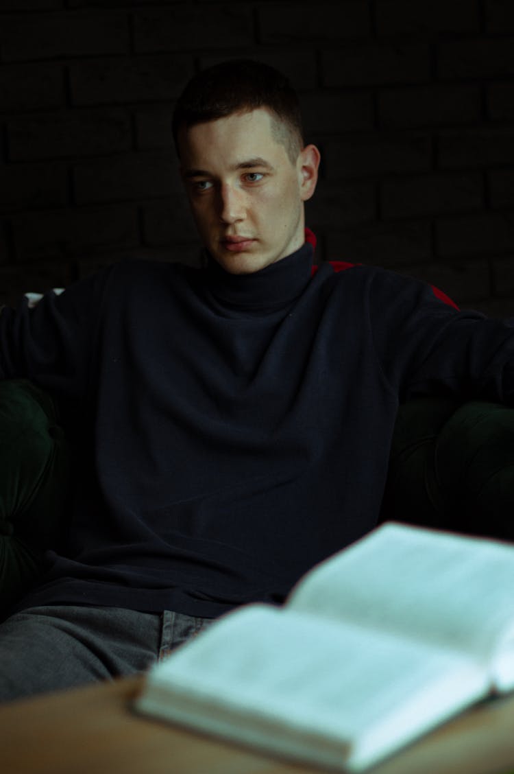 Mysterious Model In Dark Room With Book