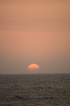 Beautiful sunset over the ocean in Cartagena, creating a serene and warm atmosphere.