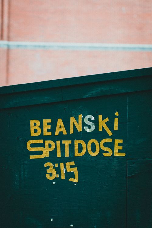 Free Close-up of colorful painted text on a green background, highlighting street art creativity. Stock Photo