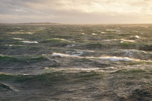 Captivating view of ocean waves under a dramatic sunset sky, showcasing nature's power and beauty.
