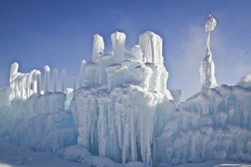 Photo of a Man on the Top of the Glacier Formation